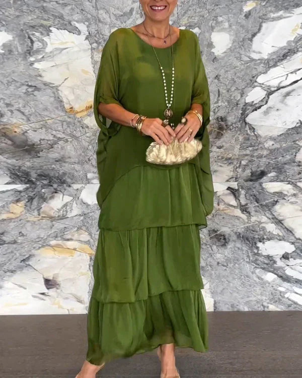 Ermeløs lang kjole i chiffon med dolman erme og rund utringning