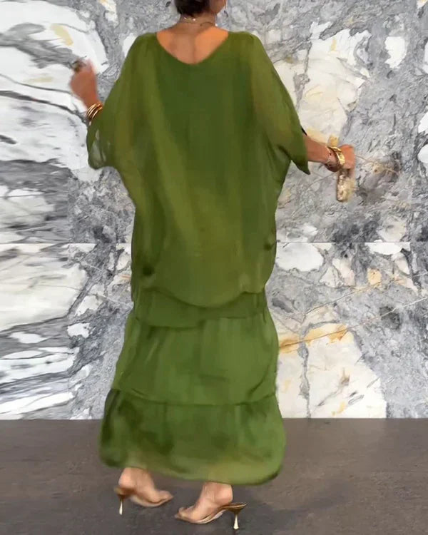 Ermeløs lang kjole i chiffon med dolman erme og rund utringning